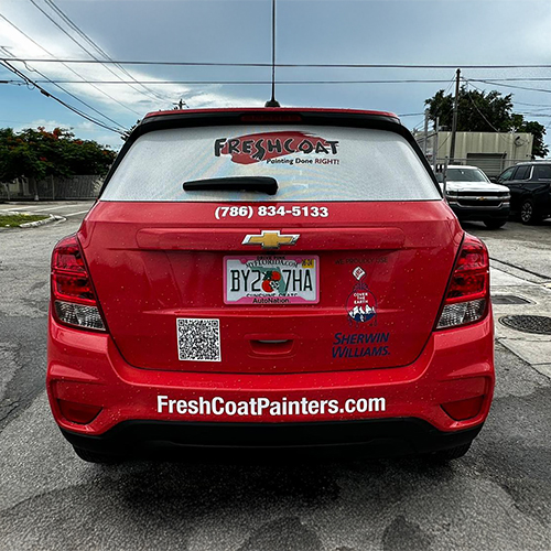 Custom perforated window graphics on a Miami business, providing privacy and advertising with high-quality design.